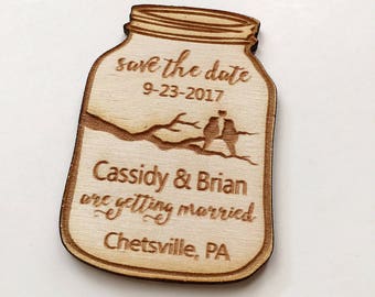 May include: Wooden save the date magnet shaped like a mason jar with the text "save the date 9-23-2017 Cassidy & Brian are getting married Chetsville, PA"
