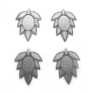 May include: Four silver-toned leaf-shaped pendants with an oval center. Each pendant features detailed leaf veins and a small loop at the top for attaching to a chain or other jewelry component. The pendants are displayed against a white background.