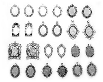 May include: A set of 20 silver-toned metal pendant trays with various ornate designs. The trays are oval, square, and rectangular in shape and have a smooth, polished finish.