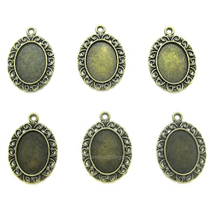 May include: Six antique gold oval-shaped pendant trays with ornate filigree designs. The trays are perfect for adding a vintage touch to jewelry making projects.
