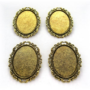 May include: Four gold-toned oval-shaped metal frames with ornate designs. The frames are blank and ready for embellishment.
