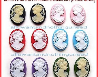 May include: Twelve 18 x 13 mm cameo-style resin embellishments featuring a woman with a ponytail. The cameos are in six colors: white, pink, blue, green, purple, and red.