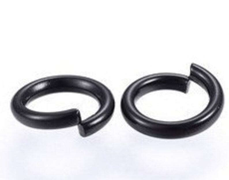 May include: Two black hoop earrings. The earrings are simple and sleek, with a smooth finish.