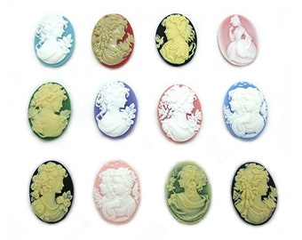 May include: Twelve oval-shaped cameo-style buttons with various colors and designs. The buttons feature a white cameo image of a woman's profile with floral accents. The buttons are approximately 1 inch in diameter.