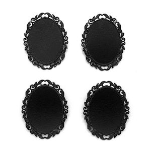 May include: Four black metal round frames with ornate designs. The frames are empty and ready to be filled with a design or image.