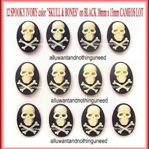 May include: Twelve ivory skull and crossbones cameo buttons on black backgrounds. Each button is 18mm x 13mm.