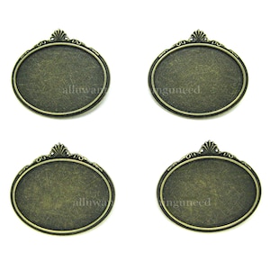 May include: Four antique gold oval-shaped metal frames with ornate detailing. The frames are blank and ready for customization.