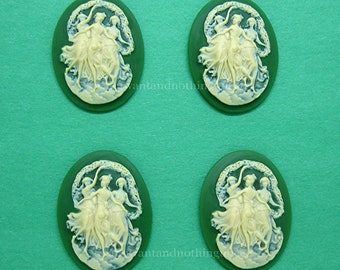 May include: Four oval-shaped green cameo buttons with a white raised design of three women dancing in a circle.