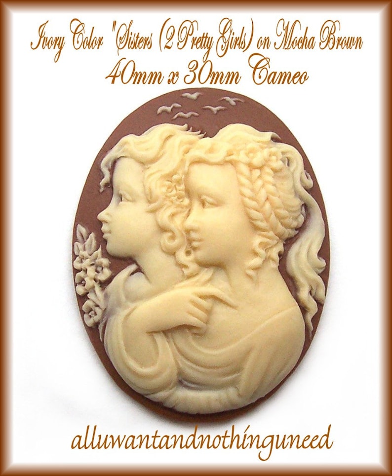 May include: Ivory cameo featuring two sisters with detailed facial features and hair, set against a mocha brown background. The cameo is 40mm x 30mm.