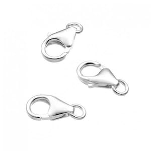 May include: Three silver lobster claw clasps for jewelry making. The clasps are made of metal and have a shiny finish.