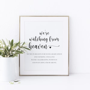 May include: A printable sign with black text on a white background. The text reads "we're watching from heaven" with a small heart symbol. Below the text is a message that reads "We're in heaven for your graduation and sending our love. We're celebrating with you and watching from above."
