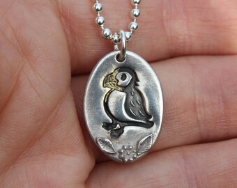 Silver puffin pendant necklace featuring an embossed puffin. A cute silver puffin necklace for any bird or wildlife lover.