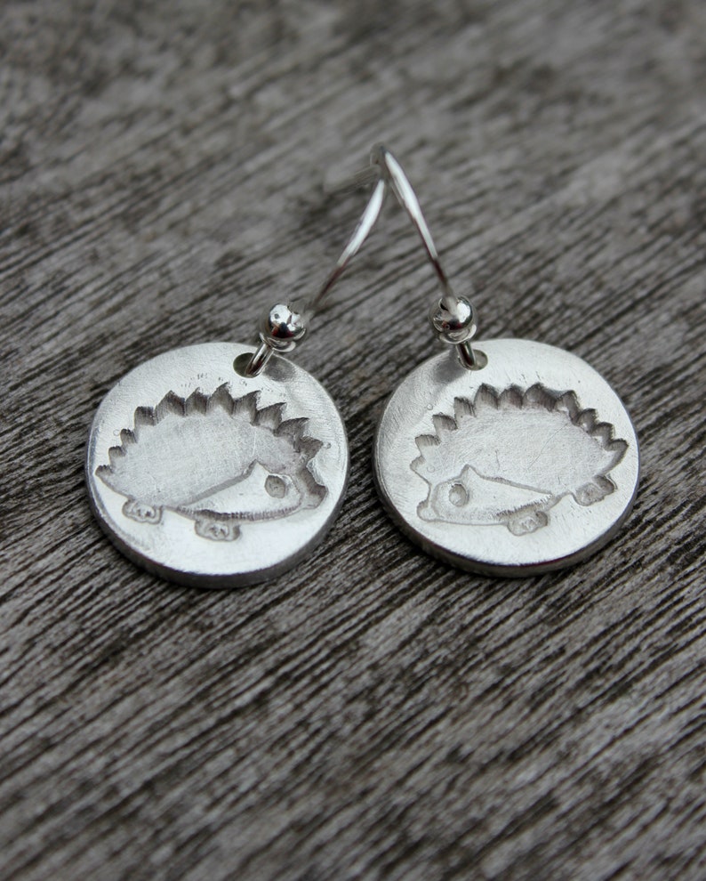 Hedgehog dangle earrings handmade in silver with an embossed hedgehog. Inspired by nature and wildlife. Perfect for a hedgehog lover. image 1