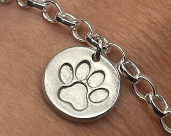 Pet paw print charm bracelet handmade in silver with a cat paw or dog paw print. The perfect gift for any pet lover or for pet remembrance.