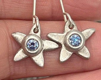 Star shaped silver gemstone drop earrings with blue Swarovski crystals - a pretty pair of sparkly earrings perfect for a special occasion.