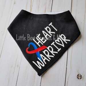 May include: Black bandana with a white heart and ribbon design. The ribbon is red and blue and the text "HEART WARRIOR" is written in white.