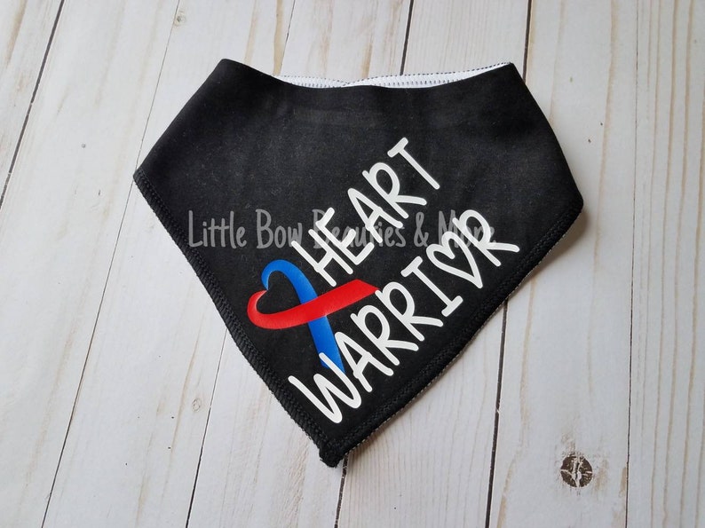 May include: Black bandana with a white heart and ribbon design. The ribbon is red and blue and the text "HEART WARRIOR" is written in white.