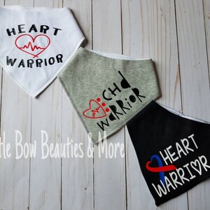May include: Three white fabric bandanas with different designs. The first bandana has a red heart with a heartbeat line and the text "HEART WARRIOR". The second bandana has a red heart with a heartbeat line and the text "CHD WARRIOR". The third bandana has a blue ribbon with a red heart and the text "HEART WARRIOR".