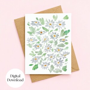 May include: A rectangular greeting card featuring a watercolor illustration of white daisies with yellow centers and green leaves, positioned on top of a brown kraft paper envelope. The design displays a repeating floral pattern.