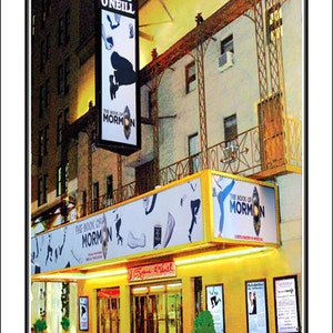 May include: A Broadway theatre marquee with the name "Eugene O'Neill" above the entrance. The marquee is lit up with yellow lights and features a large sign for the musical "The Book of Mormon".