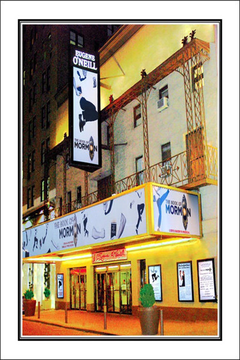 May include: A Broadway theatre marquee with the name "Eugene O'Neill" above the entrance. The marquee is lit up with yellow lights and features a large sign for the musical "The Book of Mormon".