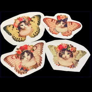 May include: Four white stickers with images of cats wearing flower crowns and butterfly wings. The cats are all different colors and have different expressions.