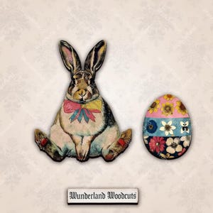 May include: A vintage-style wooden Easter bunny and egg. The bunny has a brown and white coat with a colorful bow tie. The egg is decorated with floral patterns in pink, blue, and white. The text "Wunderland Woodcuts" is at the bottom.