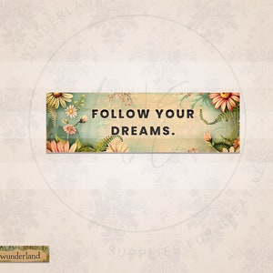 May include: A vintage-style sign with a floral background and the text "FOLLOW YOUR DREAMS."