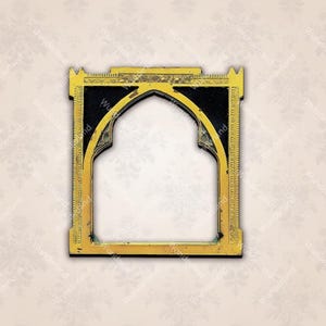 May include: A gold-colored metal frame with intricate details and a black center. The frame has an arched opening and is reminiscent of a traditional architectural design.