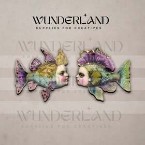 May include: Two colorful fish ornaments with human faces, each with a different hairstyle and color scheme. The fish are facing each other, with the text "WUNDERLAND SUPPLIES FOR CREATIVES" appearing above and below the fish.