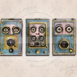 May include: Three vintage-style cameras with blue and gold accents. Each camera has a lens and two large eyes in the front. The cameras are arranged in a row against a white background.