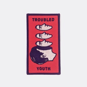 May include: Red embroidered patch with the text "Troubled Youth" and a black and white illustration of a person with multiple faces stacked on top of each other.