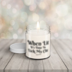 May include: A white candle in a clear glass jar with a white lid. The candle has a label that reads "When Life Gives You Lemons, It's Time To Make Some Lemonade".