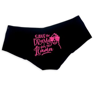 May include: Black underwear with a pink graphic print of a llama wearing sunglasses and the text "Save the drama for yo' llama".