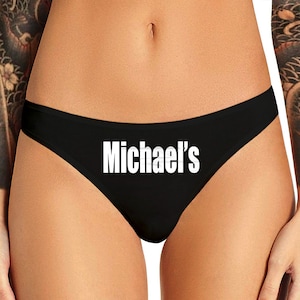 May include: Black lace underwear with the text "Michael's" printed in white.