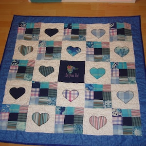 May include: A blue and white patchwork quilt with a heart design. The quilt has a blue border and a white background with blue and white squares. The hearts are cut out of the fabric and the quilt is quilted with a white thread. The quilt has the text "My Precious Gift" embroidered in the center.