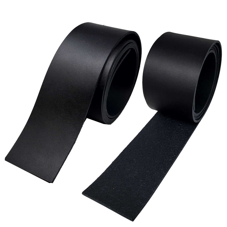 May include: Two rolls of black leather strips are displayed against a white background. One roll is partially unrolled, revealing the smooth, shiny surface of the leather. The other roll is tightly wound, showing the edge of the leather. The leather appears to be of high quality.