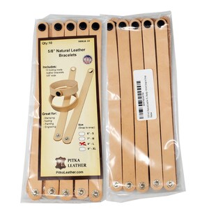 May include: Two packages of natural leather bracelets, each containing ten pieces. The packaging includes a label with the text "5/8" Natural Leather Bracelets" and "Pitka Leather". The bracelets are 1.6 cm wide and ready for stamping, tooling, painting, and engraving.