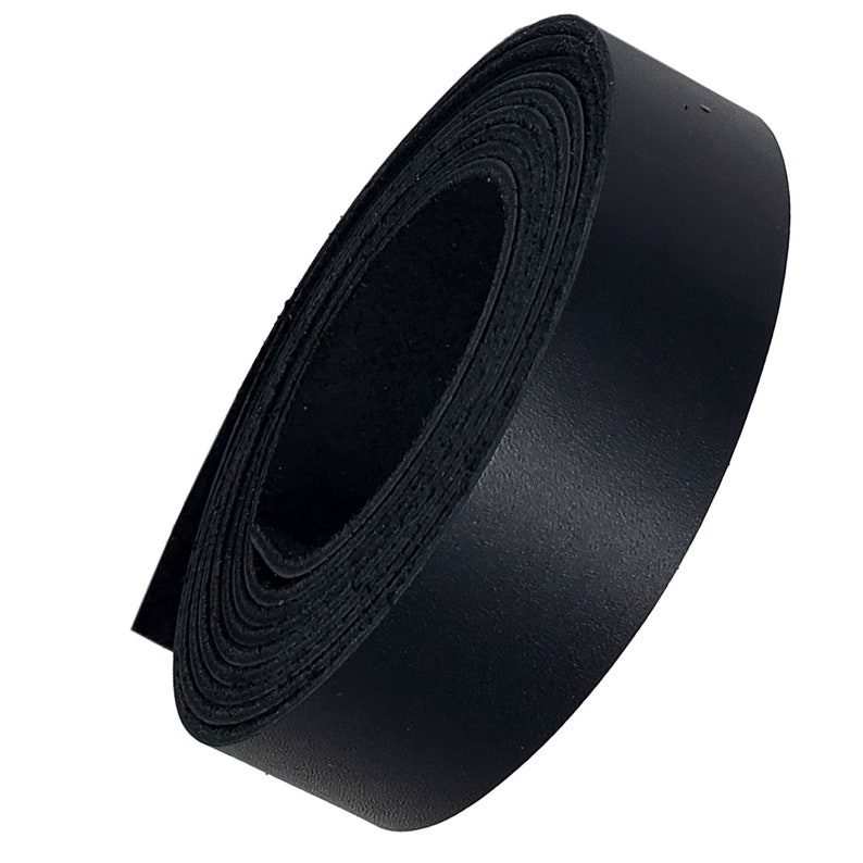 May include: A roll of black leather strip, tightly wound. The leather appears smooth and has a matte finish. The edges of the leather are visible, showing the layers of the roll. This is suitable for crafting and leatherwork projects.