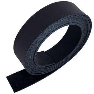 May include: A rolled-up strip of black leather, likely for crafting or repair. The leather appears smooth on one side and textured on the other. The roll is tightly wound, showcasing the material's flexibility and thickness. The background is plain white.