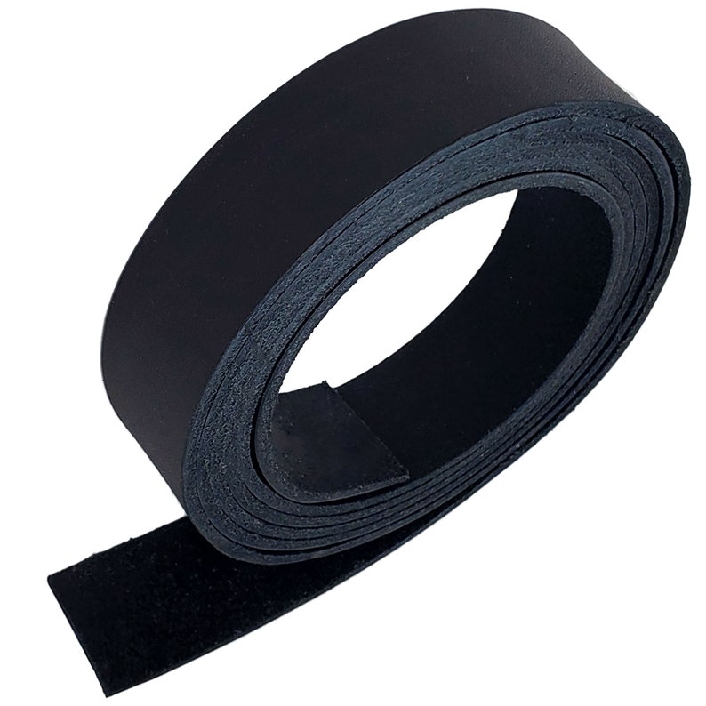 May include: A rolled-up strip of black leather, likely for crafting or repair. The leather appears smooth on one side and textured on the other. The roll is tightly wound, showcasing the material's flexibility and thickness. The background is plain white.