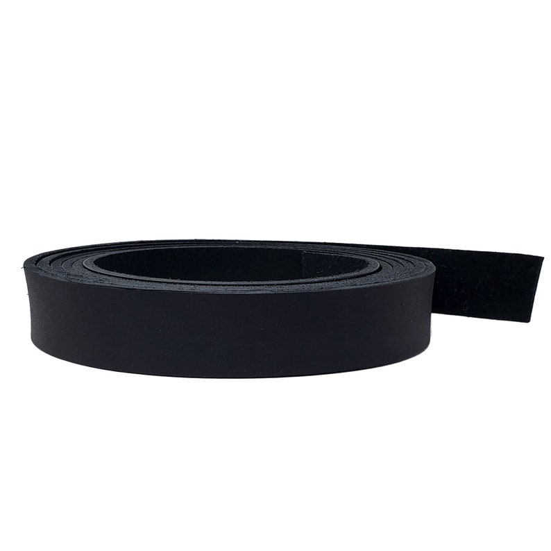 May include: A rolled-up strip of black leather, likely for crafting or repair. The leather appears smooth and has a matte finish. The roll is tightly wound, showing the thickness of the material. The background is plain white.