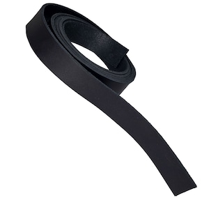 May include: A rolled-up strip of black leather, likely for crafting or repair. The leather appears to be smooth and matte, with a consistent dark color throughout. The strip is unadorned and has a clean, simple aesthetic.