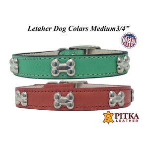 May include: Two leather dog collars, one green and one red, each with silver bone-shaped accents. The collars are medium size, 3/4 inch wide, and feature a buckle closure. The text "Letaher Dog Colars Medium 3/4" is visible.