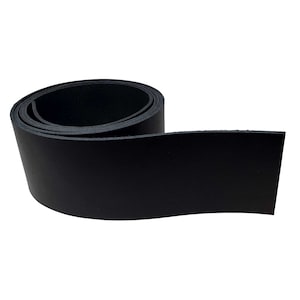 May include: A roll of black leather strip, unrolled to reveal a flat, rectangular section. The leather appears smooth and has a matte finish. The strip is likely for crafting or repair purposes.