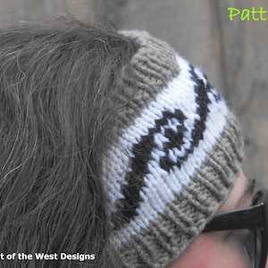 May include: A gray, white, and black knit headband with a geometric pattern. The headband is worn on a person's head with their hair pulled back.