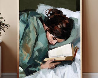 May include: An oil painting print in a wooden frame depicts a person reading a book in bed. The person is wearing a teal-colored top and has dark brown hair. The book is open, with the pages visible. The background is a mix of white and green.