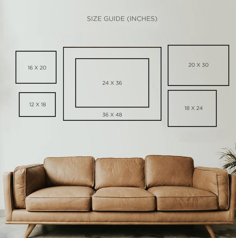 May include: A size guide for picture frames, with dimensions in inches. The guide displays rectangular frames in various sizes: 12x18, 16x20, 18x24, 20x30, 24x36, and 36x48. A brown leather sofa is in the foreground.