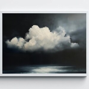 May include: A framed landscape painting depicts a dramatic sky with a large, fluffy white cloud against a dark, moody background. The bottom of the painting shows a reflective body of water, with the white frame adding a clean border.