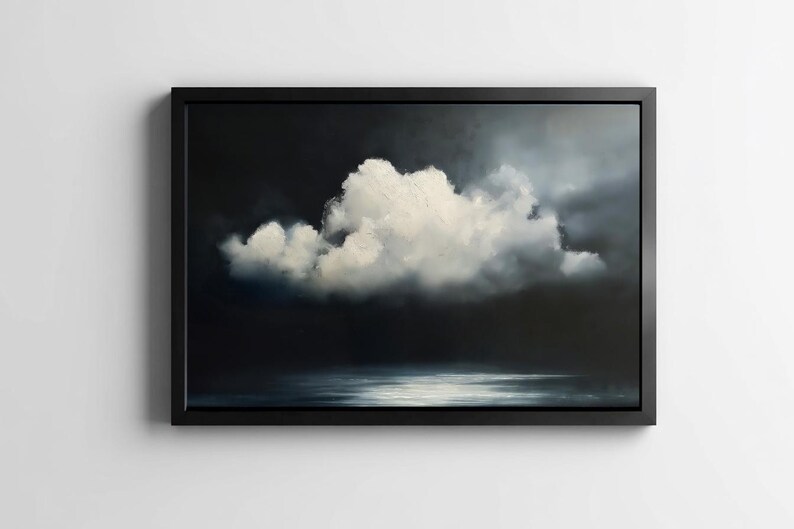 May include: A framed artwork depicting a dramatic cloudscape. A large, fluffy white cloud dominates the center against a dark, moody background. The artwork is framed in a simple black frame, creating a striking contrast.